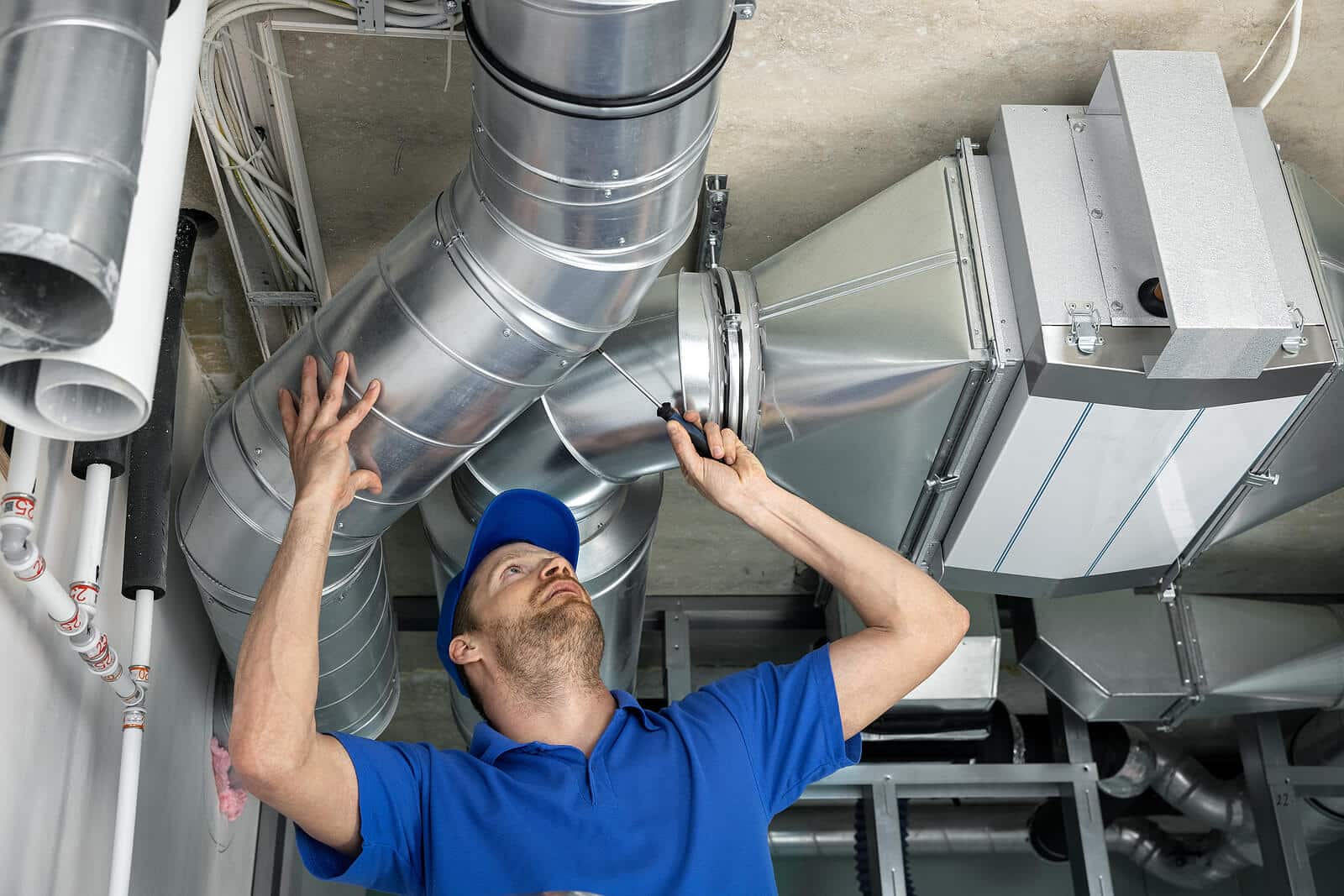 HVAC technician inspecting and repairing air ducts in Baldwin Park