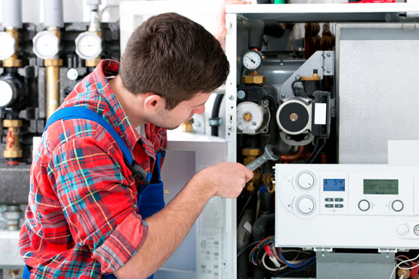 Heating technician repairing boiler controls in Baldwin Park