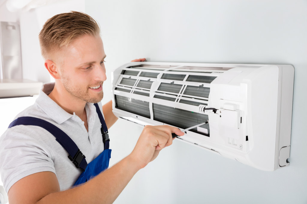 HVAC technician maintaining a ductless air conditioner in Baldwin Park
