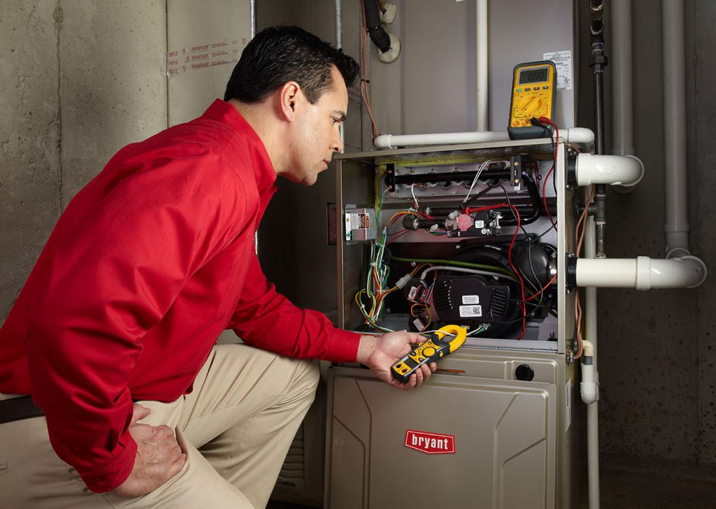Heating technician diagnosing a furnace repair in Baldwin Park