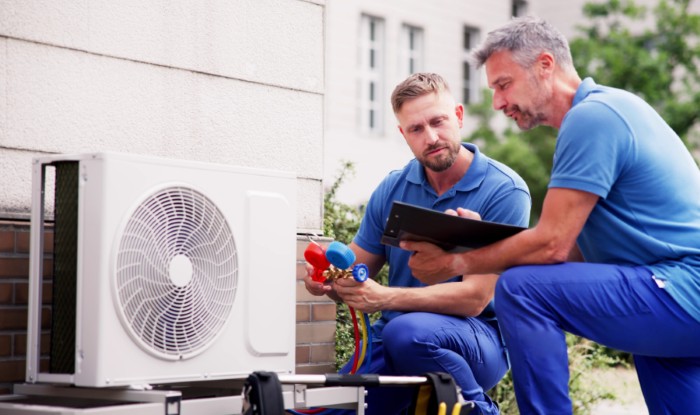 HVAC technicians installing an outdoor air conditioning unit in Baldwin Park