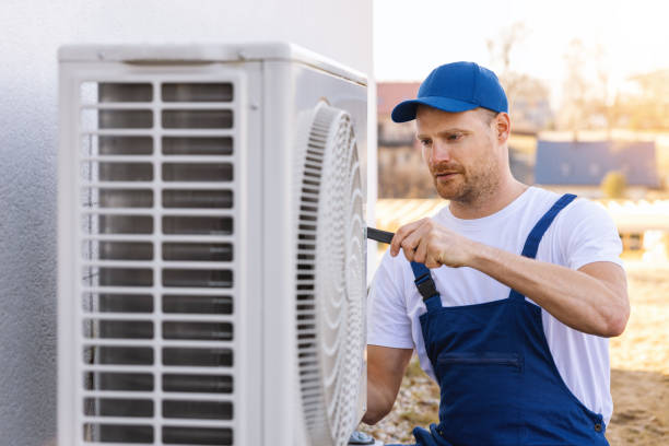 HVAC technician servicing an outdoor air conditioner in Baldwin Park