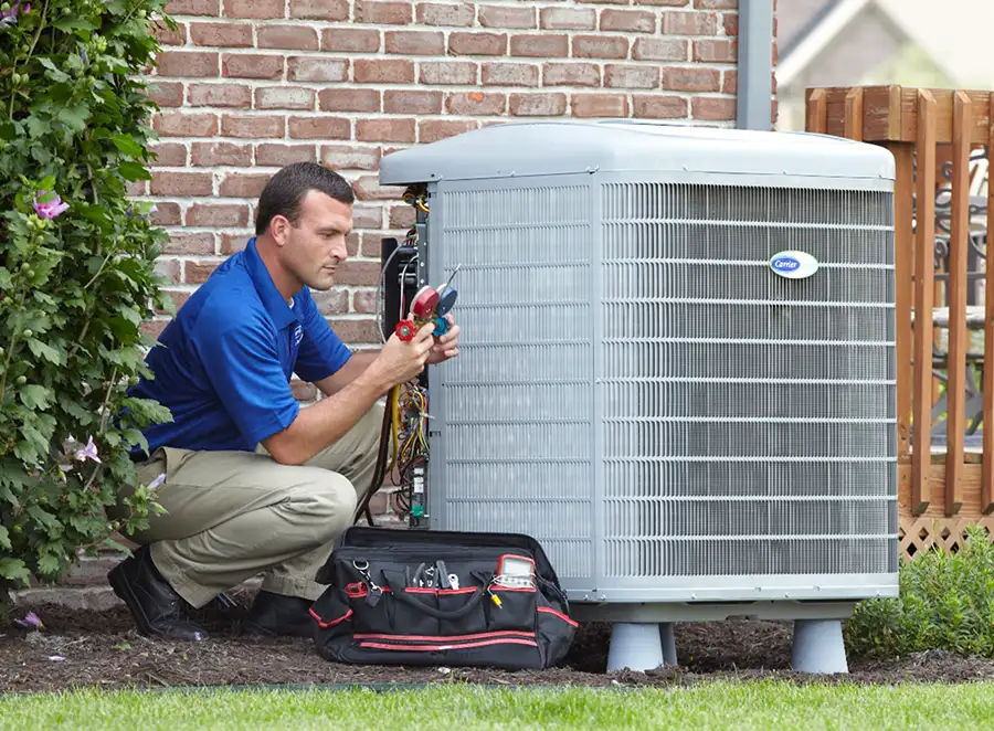 HVAC technician inspecting an outdoor AC unit in Baldwin Park